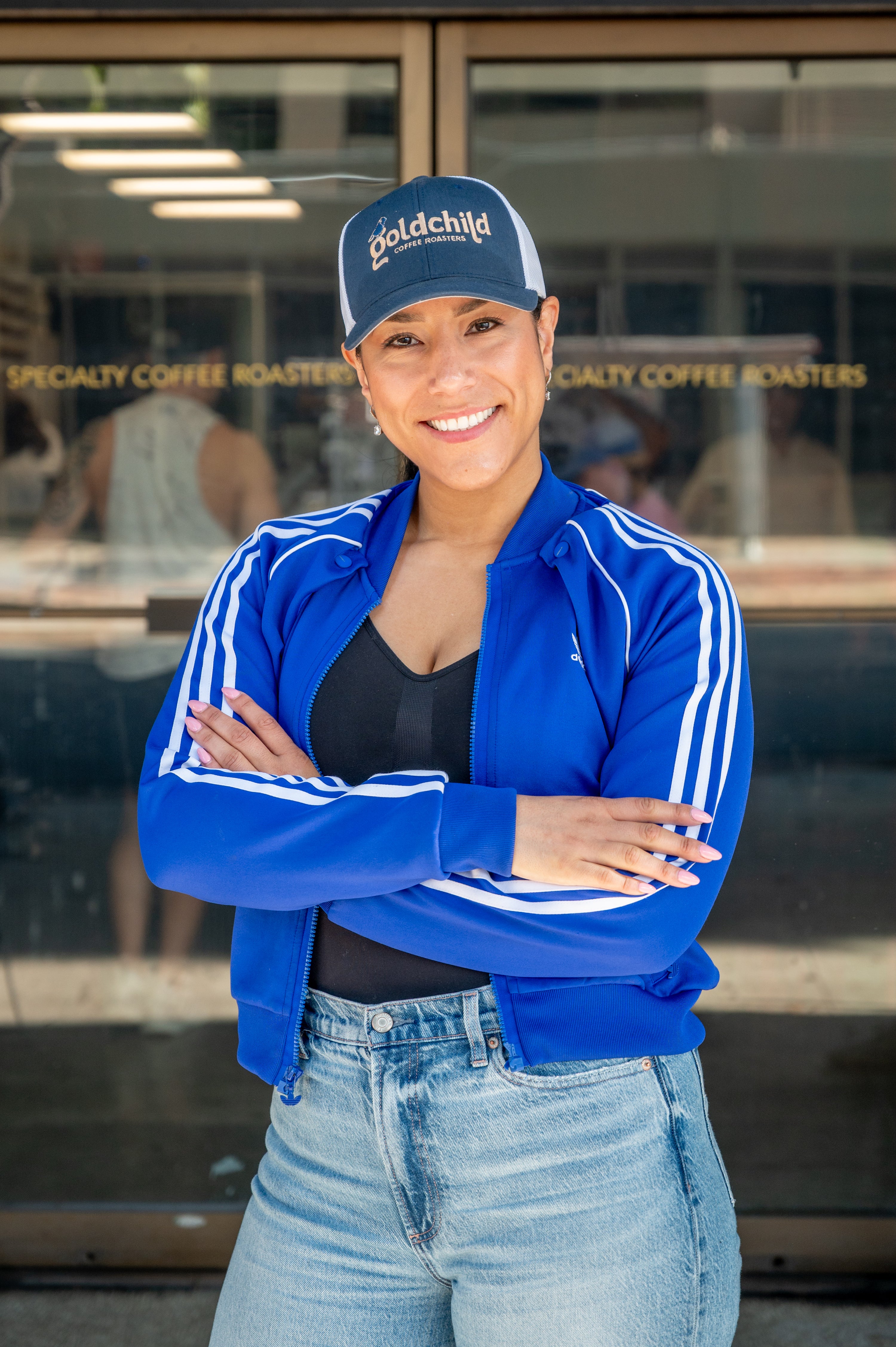 Mariela Mosquera, co-founder of Goldchild Coffee, standing in front of the shop